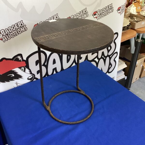 Vintage small round table with wooden top and metal leg.