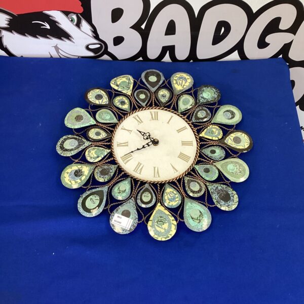 Vintage metal wall clock with verdigris patina and Roman numerals.