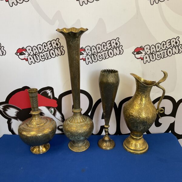 Set of three intricately engraved Indian brass vases.