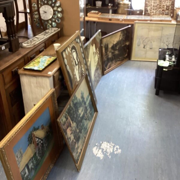Vintage collection of framed prints and paintings for wall decor.
