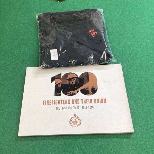 Vintage fire service T-shirt and history booklet, collectible memorabilia.