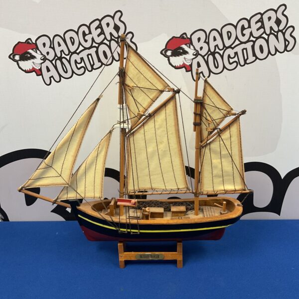 Vintage wooden Brixham trawler model boat with detailed sails and rigging.
