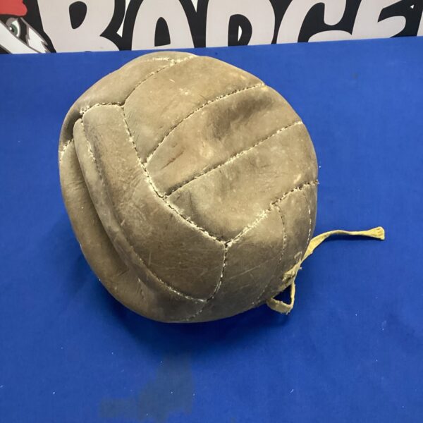 Antique leather football from the turn of the century, showing wear.
