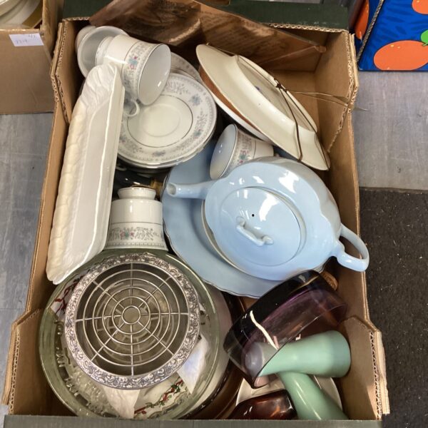 Mixed china lot with rose bowl and vintage teacups on display.