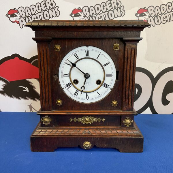 Vintage Junghans mantle clock with oak case and white dial.