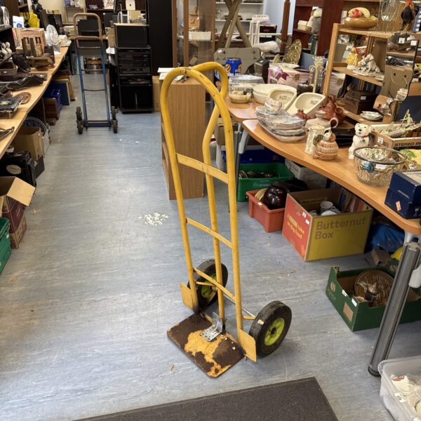 Vintage sack barrow in a cluttered antique shop setting.
