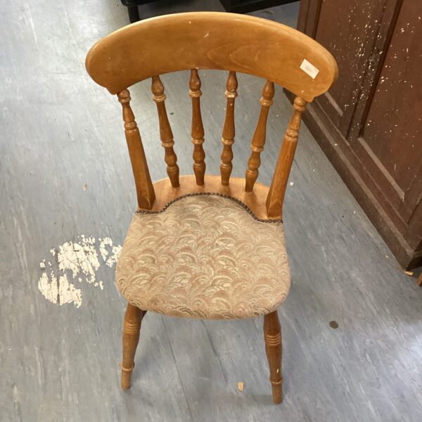Light oak spindle back dining chair with upholstered seat.