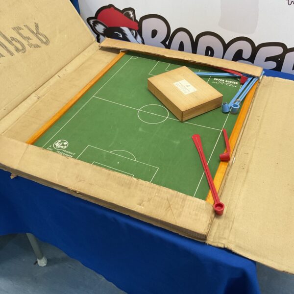 Vintage Super Soccer magnetic football game on a table.