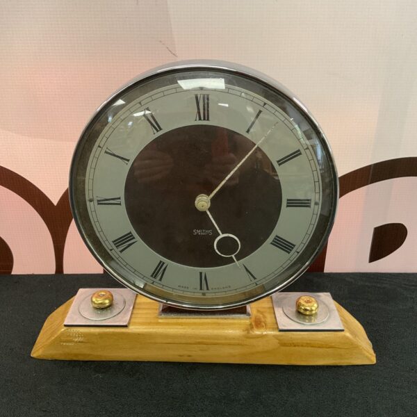 Vintage Smiths mantle clock with circular dial and wooden case.