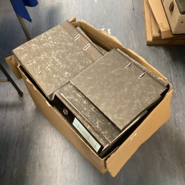 Large box filled with ring binders for document organisation.