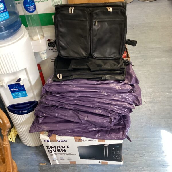 Large lot of black leather handbags for sale.