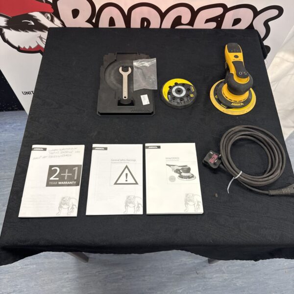 Mirka Deros sander with included accessories and manuals.