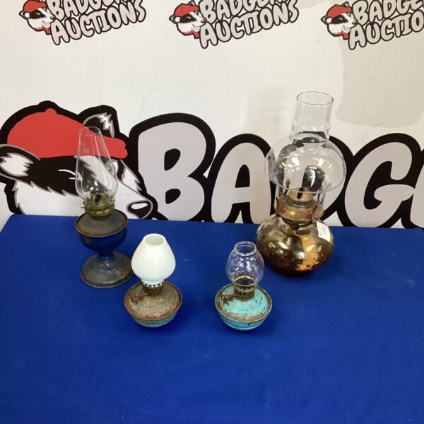 Group of four vintage oil lamps, antique kerosene lighting.