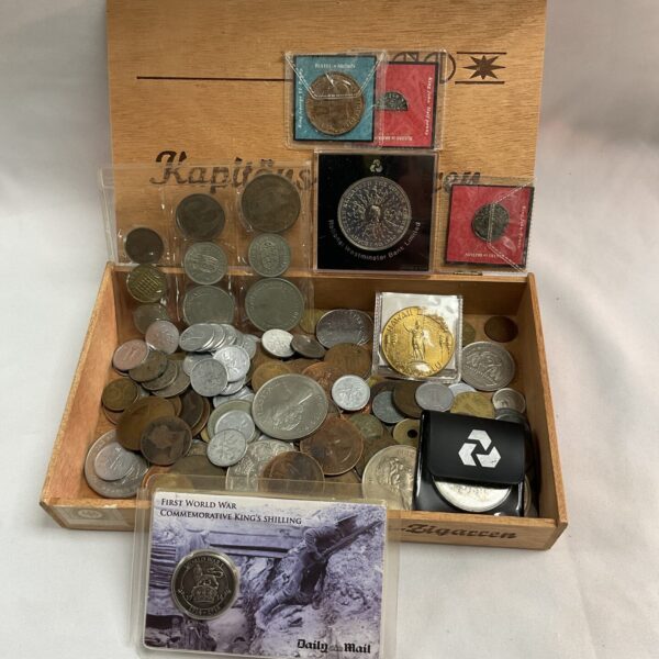 Assorted coin collection in a vintage cigar box, ideal for collectors.
