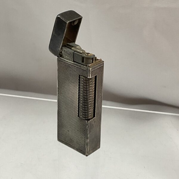 Vintage Dunhill gas lighter with textured silver finish.