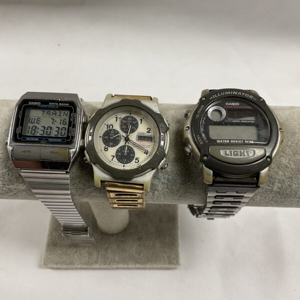 Lot of three vintage Casio digital watches with stainless steel bands.