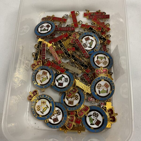 Tray of vintage RAC British Grand Prix enamel pin badges.