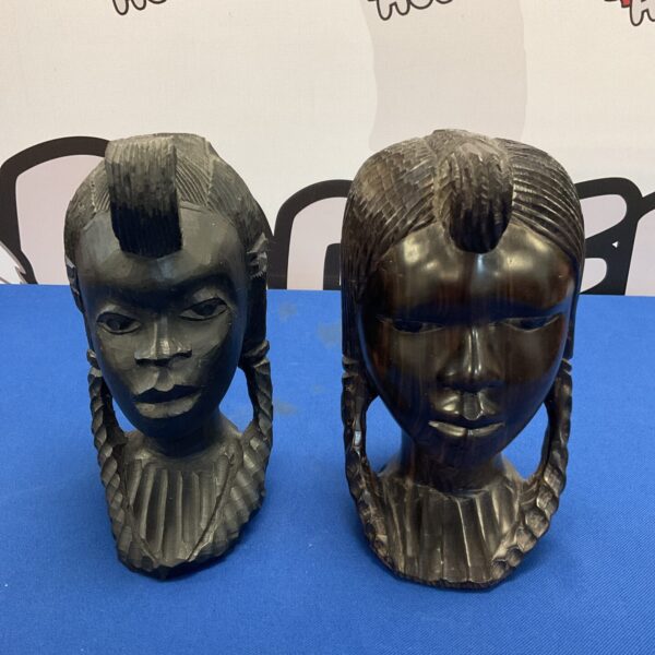 Vintage African tribal busts, hand-carved wood sculptures of young girls.