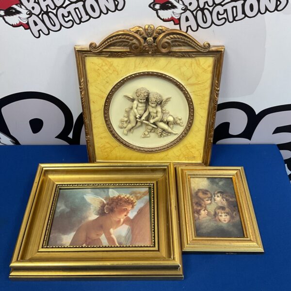 Vintage cherub wall plaque with two framed prints.