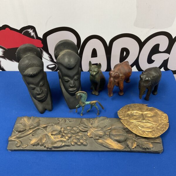 Vintage African carved wooden busts with museum replica artifacts.