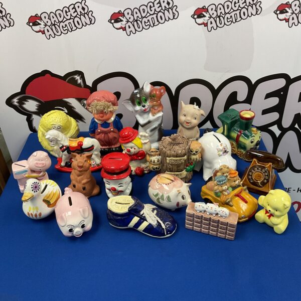 Vintage moneybox collection featuring Fujika cats and ceramic pigs.