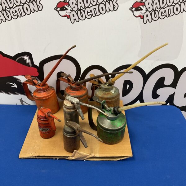 Collection of seven vintage oil cans including a Wesco brand.