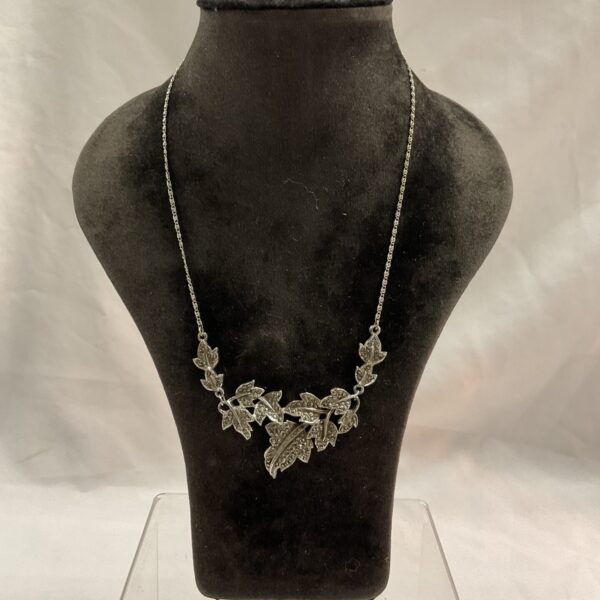 Close-up of vintage marcasite necklace with silver leaf pendant.