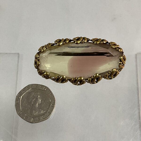 Vintage smoky quartz brooch with gold-tone setting.