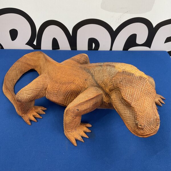 Detailed hand-carved wooden Komodo dragon sculpture with visible scales.