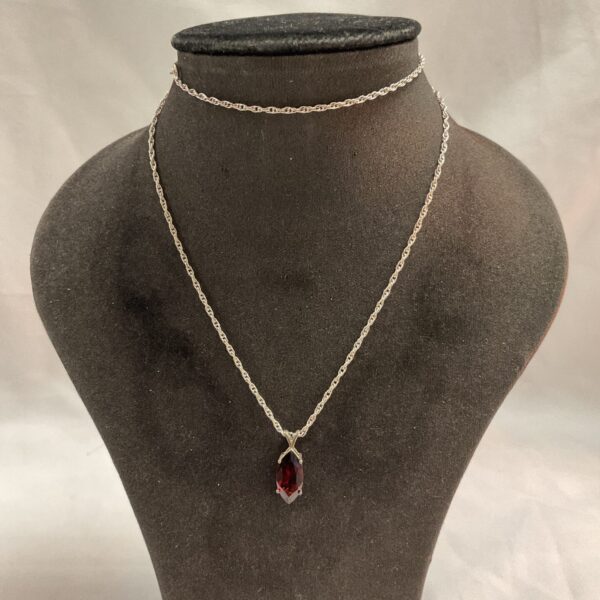 Vintage silver necklace with ruby colour faceted cage pendant.