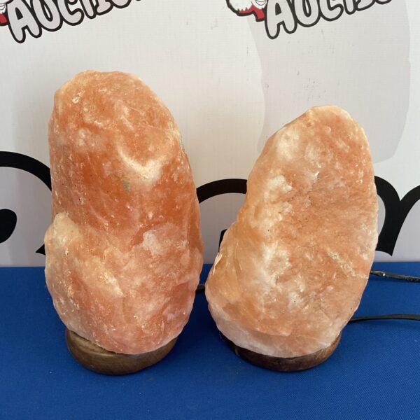 Pair of Himalayan salt lamps on a white surface.