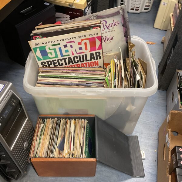 Large lot of vinyl records in a plastic storage container.