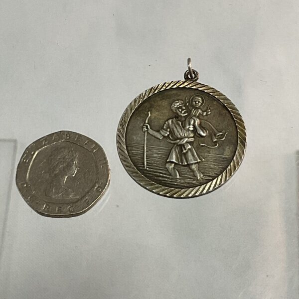 Vintage silver St Christopher pendant with detailed relief design.