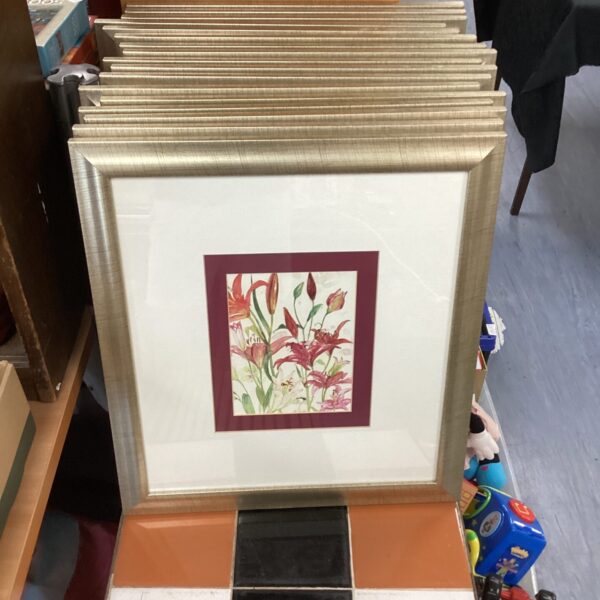 Framed floral print depicting detailed botanical illustration, vintage style wall art.
