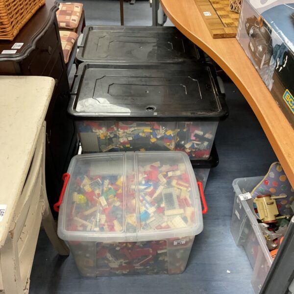 Overview of five large containers of mixed Lego bricks.