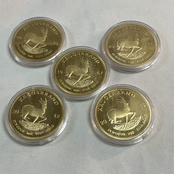 Lot of five replica Krugerand coins with springbok design.