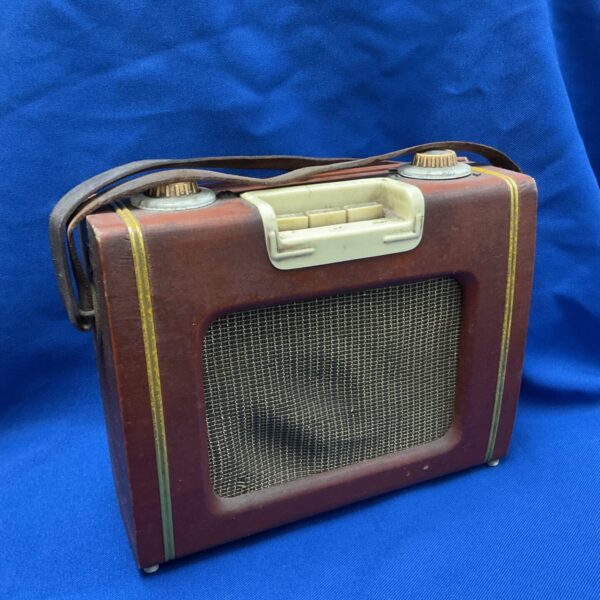 Front view of a vintage transistor radio with tuning dial.