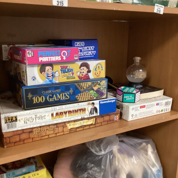 Vintage board game lot with colourful boxes and puzzle pieces.