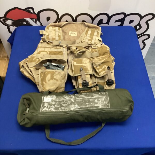 British Army desert assault vest with rolled tents attached.