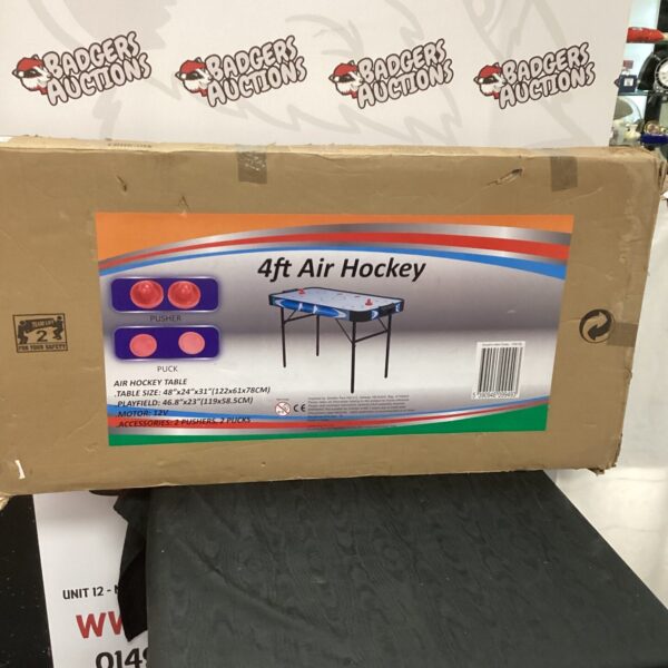 Air hockey table in original packaging, ready for a game room.