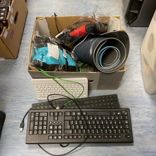 Mixed lot of computer keyboards and new dog jackets for sale.