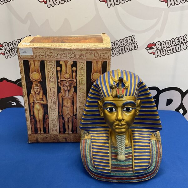 Detailed gold Tutankhamun bust, ancient Egyptian pharaoh sculpture.