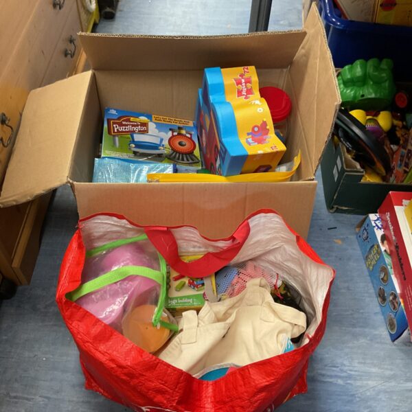 Assorted childrens toys in a bag and box.