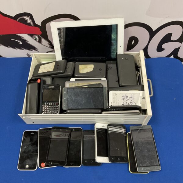 Tray of used mobile phones including iPhones and smartphones.