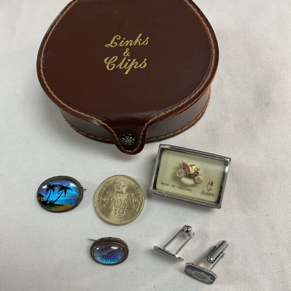 Vintage brown leather links and clips box with jewellery inside.