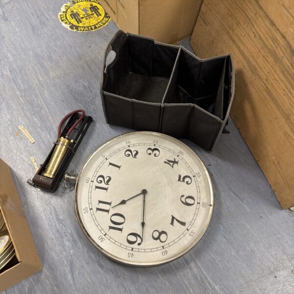 Vintage quartz wall clock with car boot organiser and foot pump.