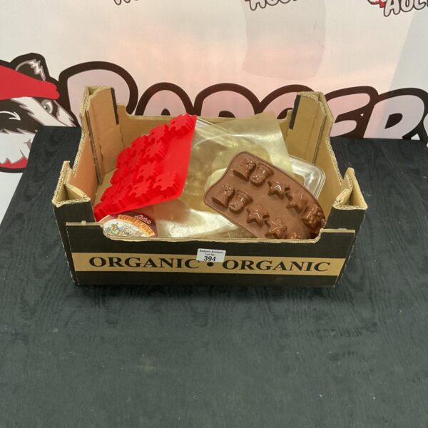 Box of assorted polycarbonate chocolate moulds for baking.