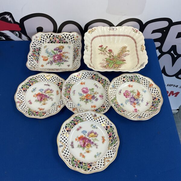 Close-up of Copeland Rosalie and Schumann antique china plates.