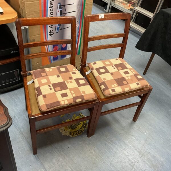 Pair of vintage ladder back chairs with upholstered seats.