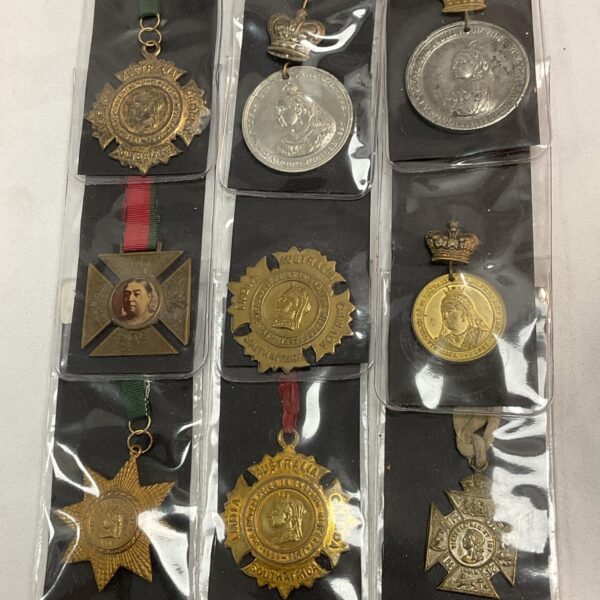 Lot of nine antique Victoria commemorative medals, detailed Victorian craftsmanship.